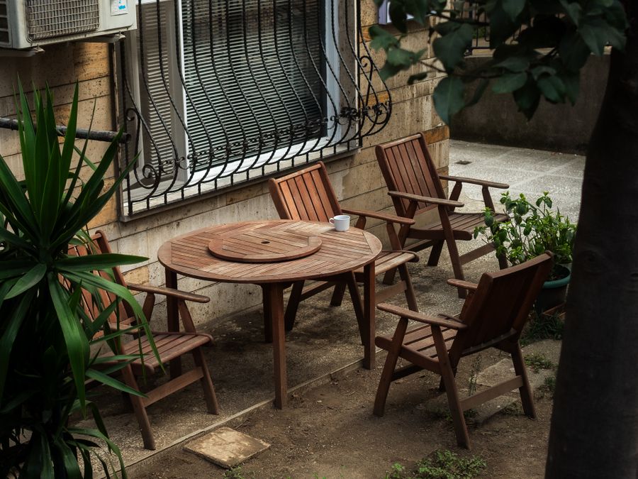 Garden patio with wooden table and chairs