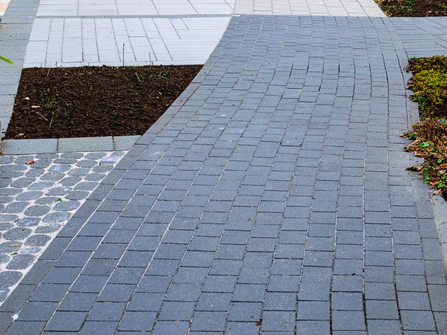 Curved block paved path with planted borders